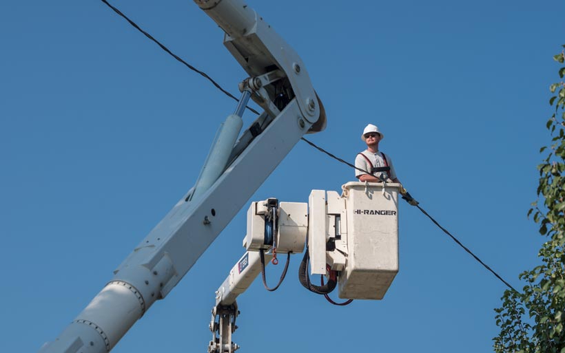 Barbourville Utility Commission electric lineman in lift bucket.
