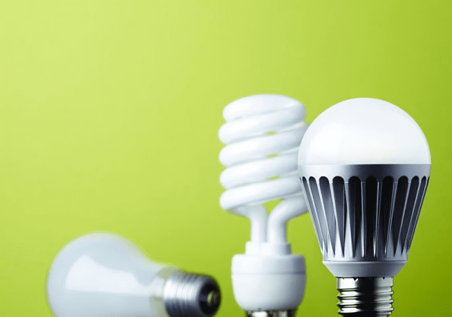 A green background with three different types of light bulbs.