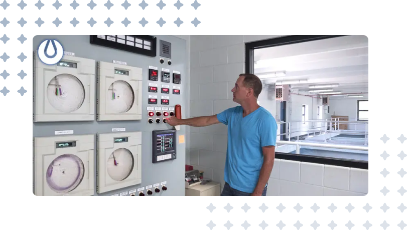 A man is pointing to the wall of an electrical panel.